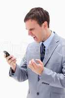 Angry businessman yelling at his cellphone