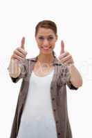 Thumbs up given by smiling woman