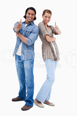 Smiling couple giving thumbs up