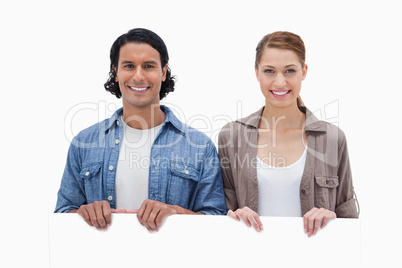 Couple looking over blank wall
