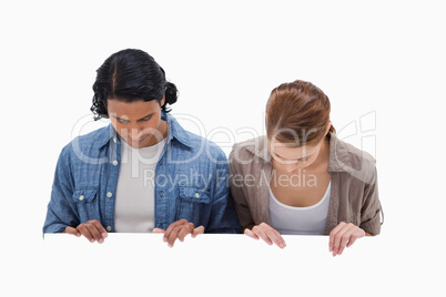 Couple looking down on blank wall