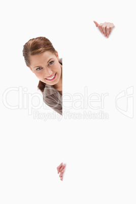 Woman looking around blank sign
