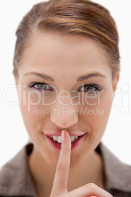 Smiling woman asking for silence