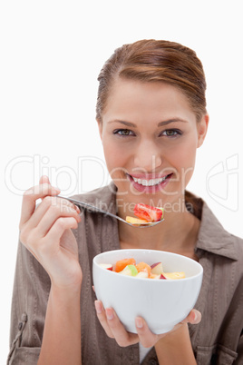 Woman eating fruit salad