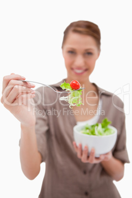 Woman offering salad on a fork