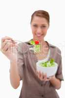 Woman offering salad on a fork