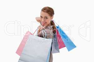 Side view of smiling woman with shopping bags