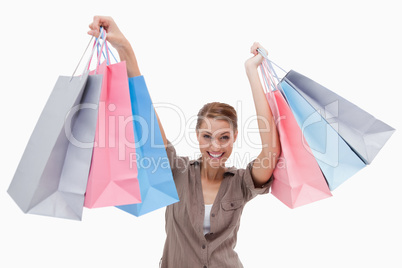 Woman raising her shopping bags