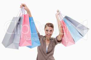 Woman raising her shopping bags