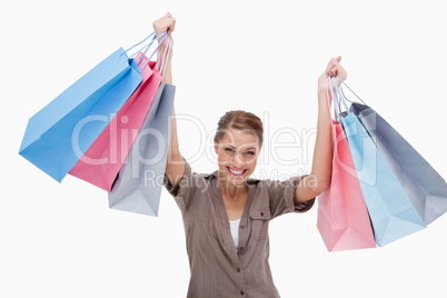 Happy woman raising her shopping bags