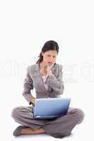 Sitting woman having trouble with laptop