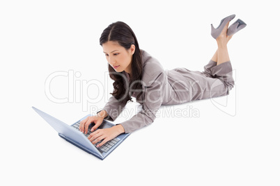 Lying woman working on her laptop