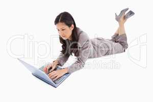 Lying woman working on her laptop