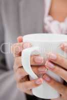 Cup being held by female hands