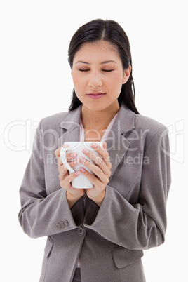 Woman enjoys the smell of her fresh coffee