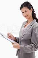 Side view of businesswoman taking notes