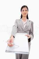 Confident businesswoman asking for signature