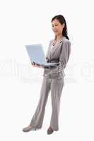 Side view of laughing businesswoman with laptop