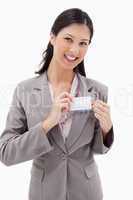 Smiling businesswoman putting on name badge