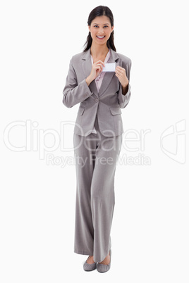 Businesswoman putting on name badge