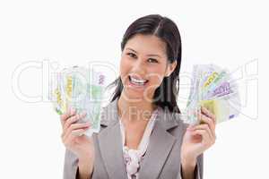 Smiling businesswoman holding money in her hands
