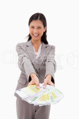 Money being offered by smiling businesswoman