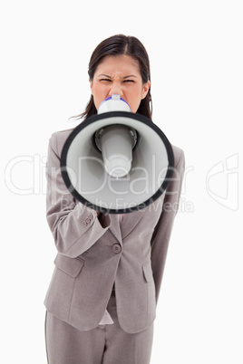 Angry businesswoman yelling through megaphone