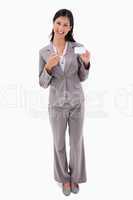 Smiling businesswoman pointing at blank name bagde