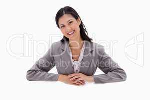 Businesswoman leaning on blank wall