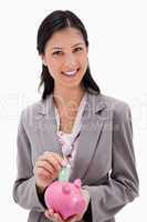 Businesswoman with money and piggy bank