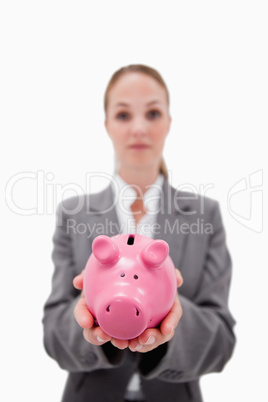 Piggy bank being held by bank employee