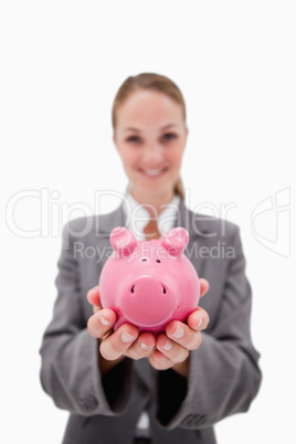 Piggy bank being offered by smiling bank employee