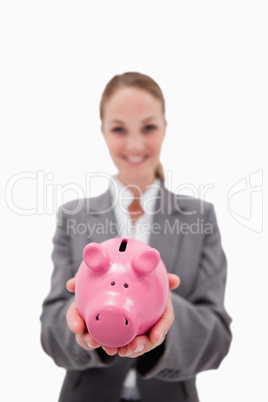 Piggy bank being held by smiling bank employee