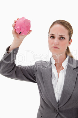Sad bank employee with empty piggy bank