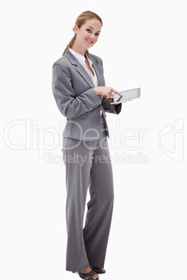Side view of smiling bank employee using tablet