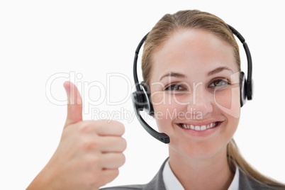 Smiling call center agent giving thumb up