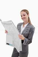 Portrait of a smiling businesswoman reading the news