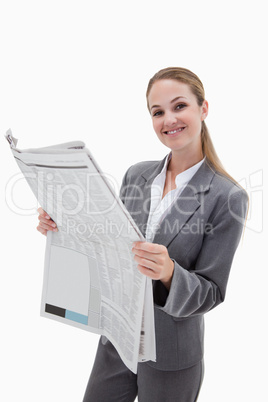 Portrait of a happy businesswoman reading the news