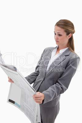 Portrait of a surprised businesswoman reading the news