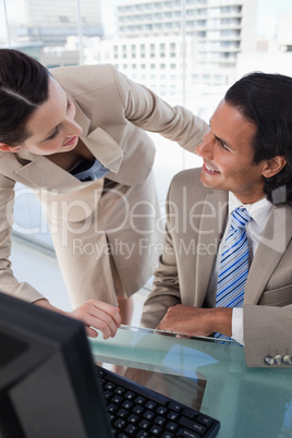 Portrait of a smiling business team using a monitor