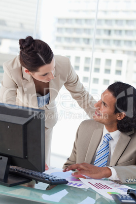 Portrait of a happy business team studying statistics