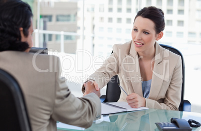 Manager shaking the hand of a male applicant