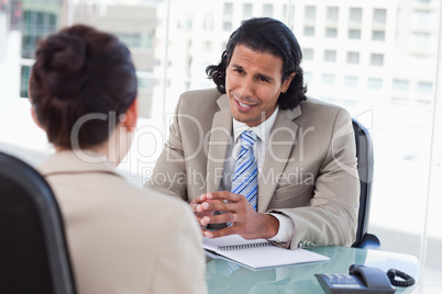 Smiling manager interviewing a female applicant Smiling manager interviewing a female applicant