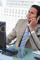 Portrait of a handsome businessman working with a monitor while