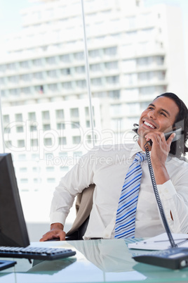 Portrait of a delighted businessman on the phone