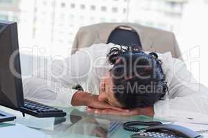 Tired businessman sleeping on his desk