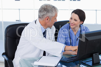 Smiling medical team working with a computer