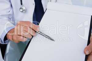 Close up of a male doctor showing a blank document