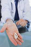Portrait of a hand showing pills