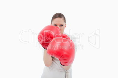 Businesswoman wearing boxing gloves